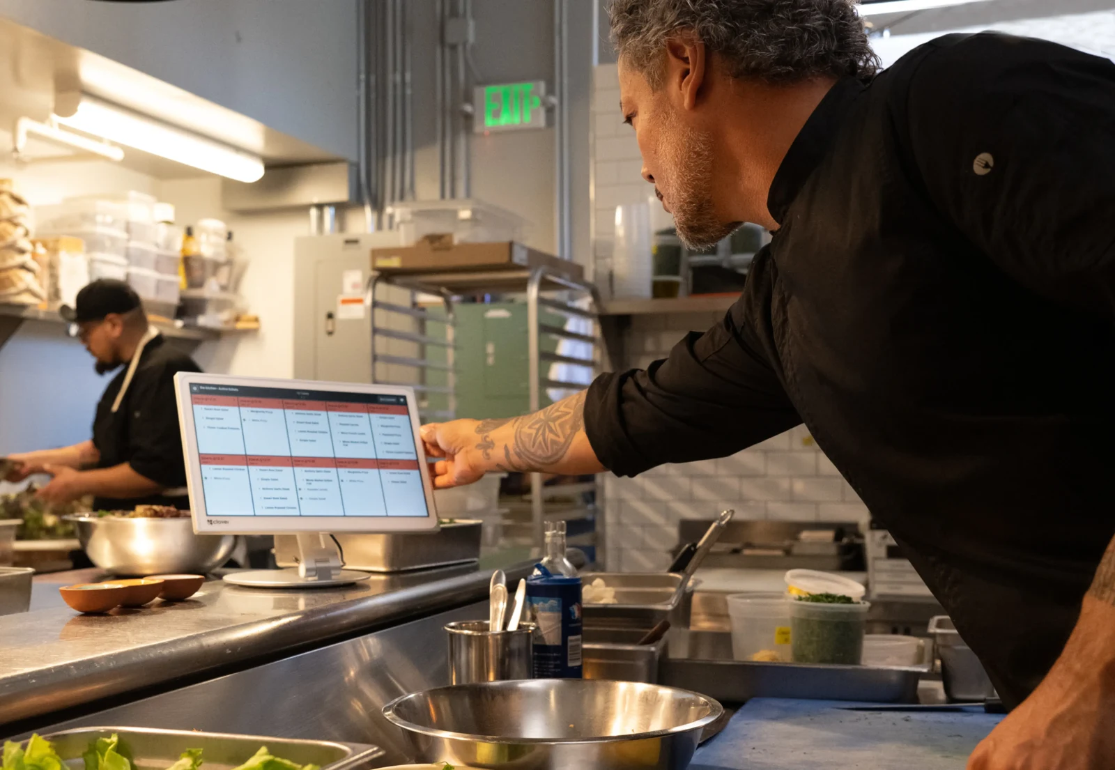 A restaurant team using a Clover kitchen display